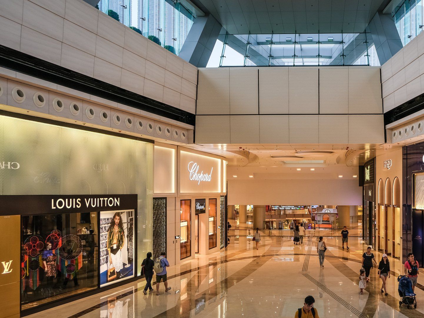 a large shopping mall with a louis vuitton store in the middle .