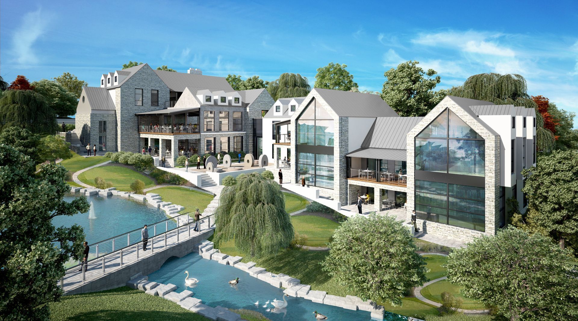 Modern multi-building complex with stone and white exteriors next to a lake, bridge, and greenery under blue sky.