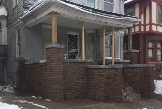 Fully repaired porch columns and rebuilt brick foundation following EFD Masonry’s restoration work in Oakland County.