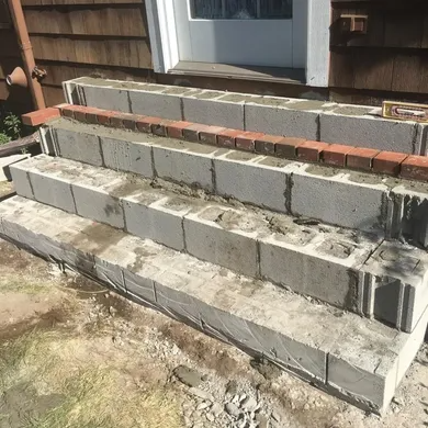 Partially built cinder block steps under EFD Masonry’s porch restoration in Oakland County.