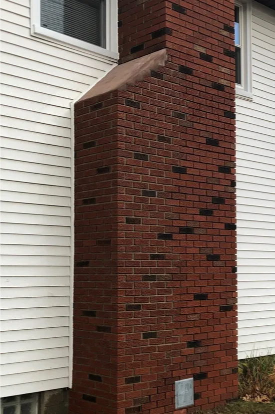 Completed brick chimney restoration by EFD Masonry in Oakland County, featuring newly matched bricks and clean mortar lines.