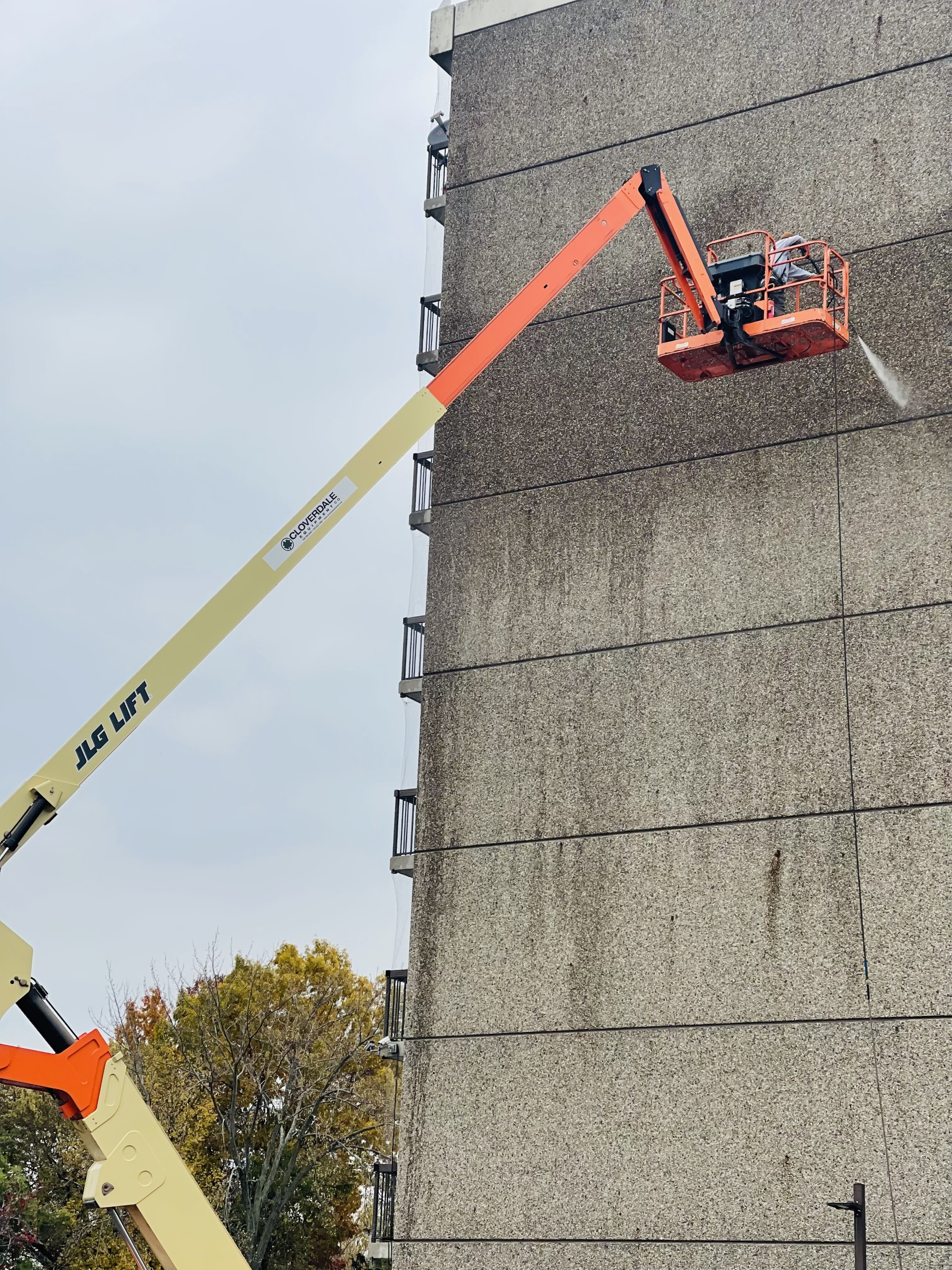 EFD Masonry crew power washing the concrete façade of Saint Sarkis Towers in Dearborn, Michigan.