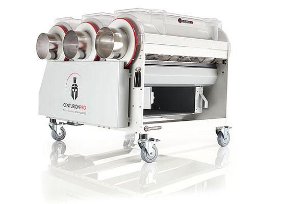 White industrial machine on caster wheels with three red-rimmed rollers and a control panel on the side