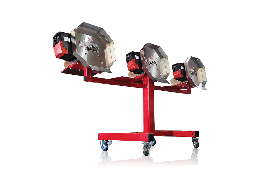 Red wheeled stand holding three large silver work lights on adjustable mounts