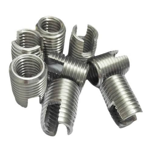 A bunch of stainless steel inserts are stacked on top of each other