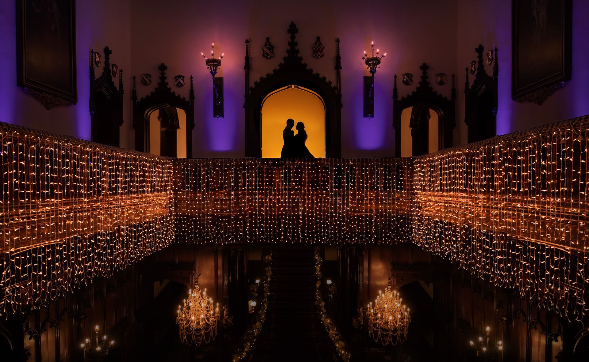 A silhouette of a wedding couple, lit with