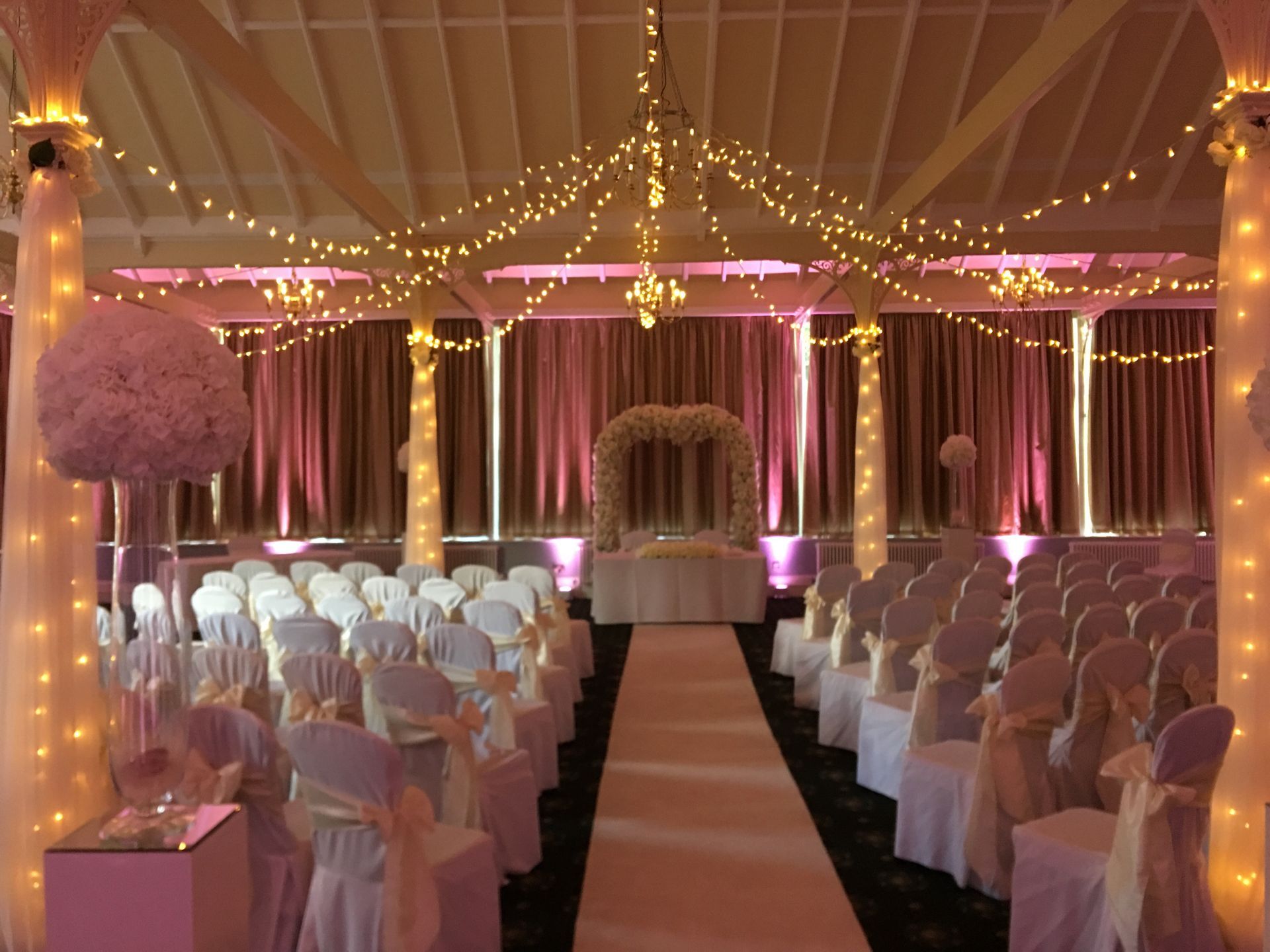Fairy Light Celling Canopy in warm white, pale pink uplighting and fairy light pillars. Deco and Lights from Exclusive Entertainments, Harro