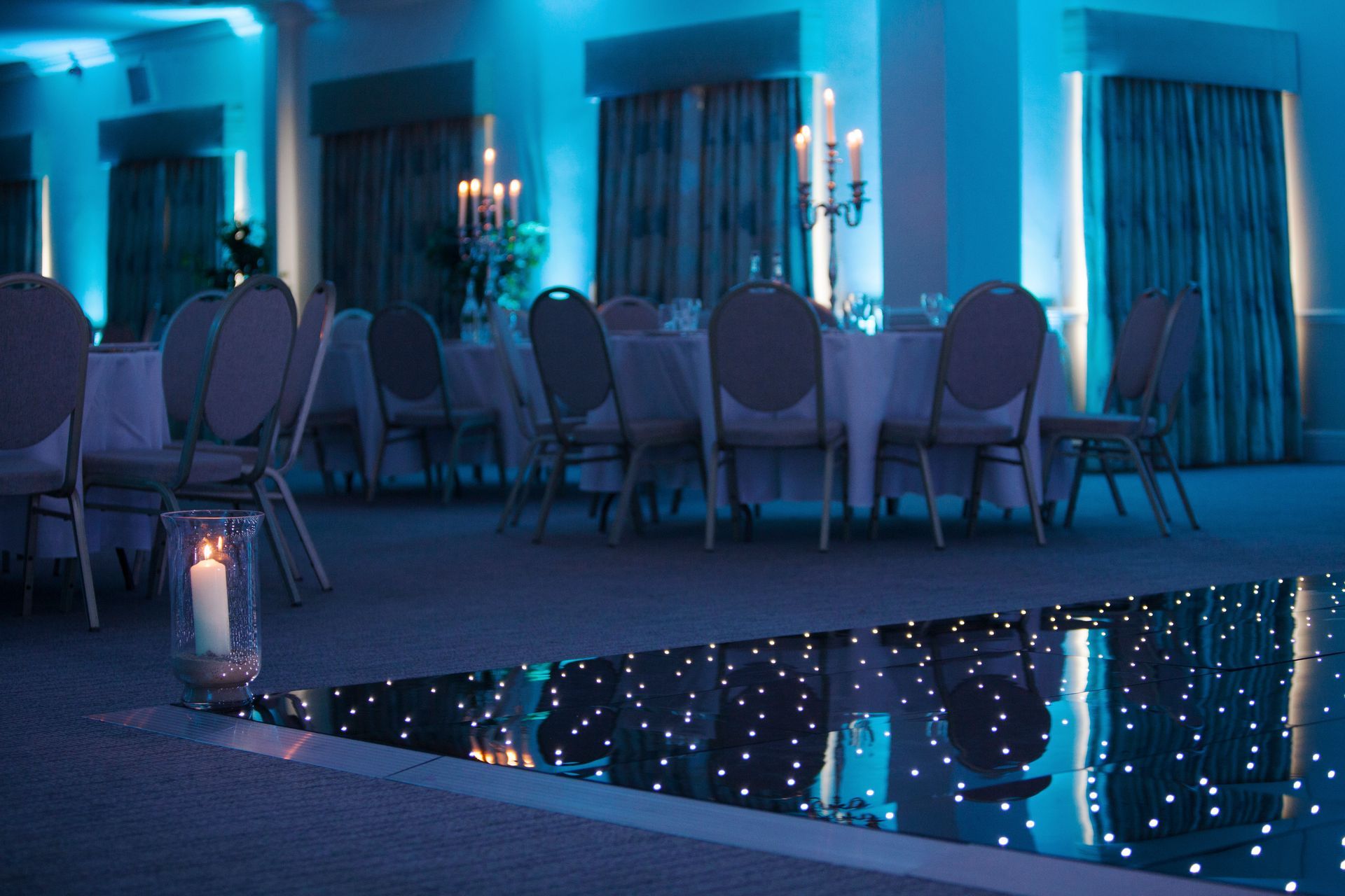 Decor lit with cool white and blue lighting. Black base with sparkly white lights for this light up dance floor. Production services and equipment  hire for this event was supplied by Exclusive Entertainments Harrogate,Yorkshire