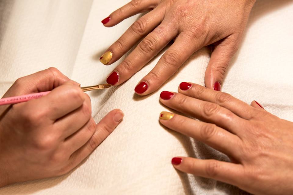 applicazione di smalto semipermanente rosso e dorato