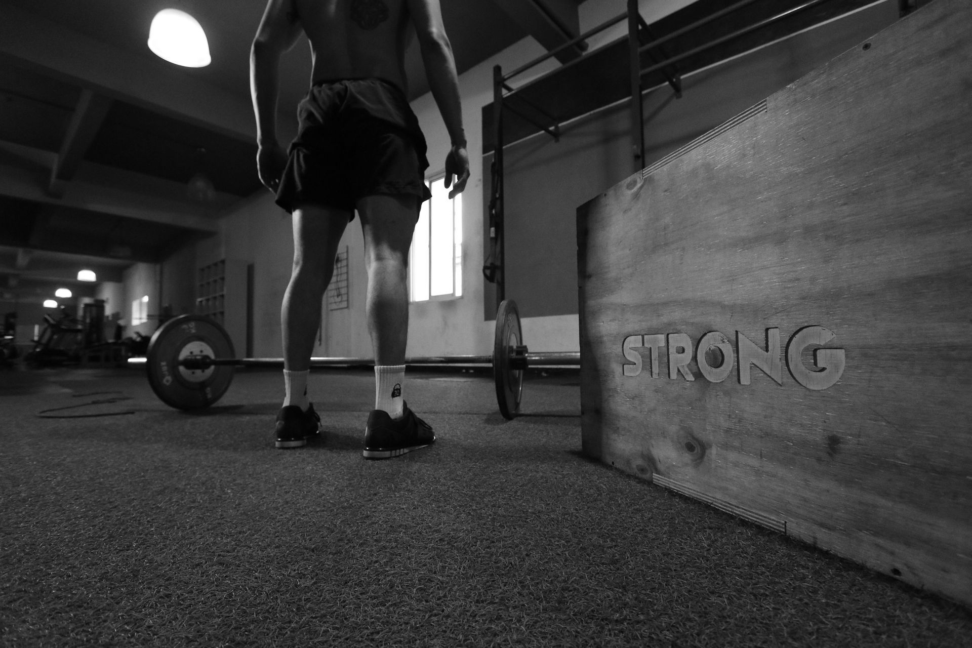 Man standing near a barbell and a 