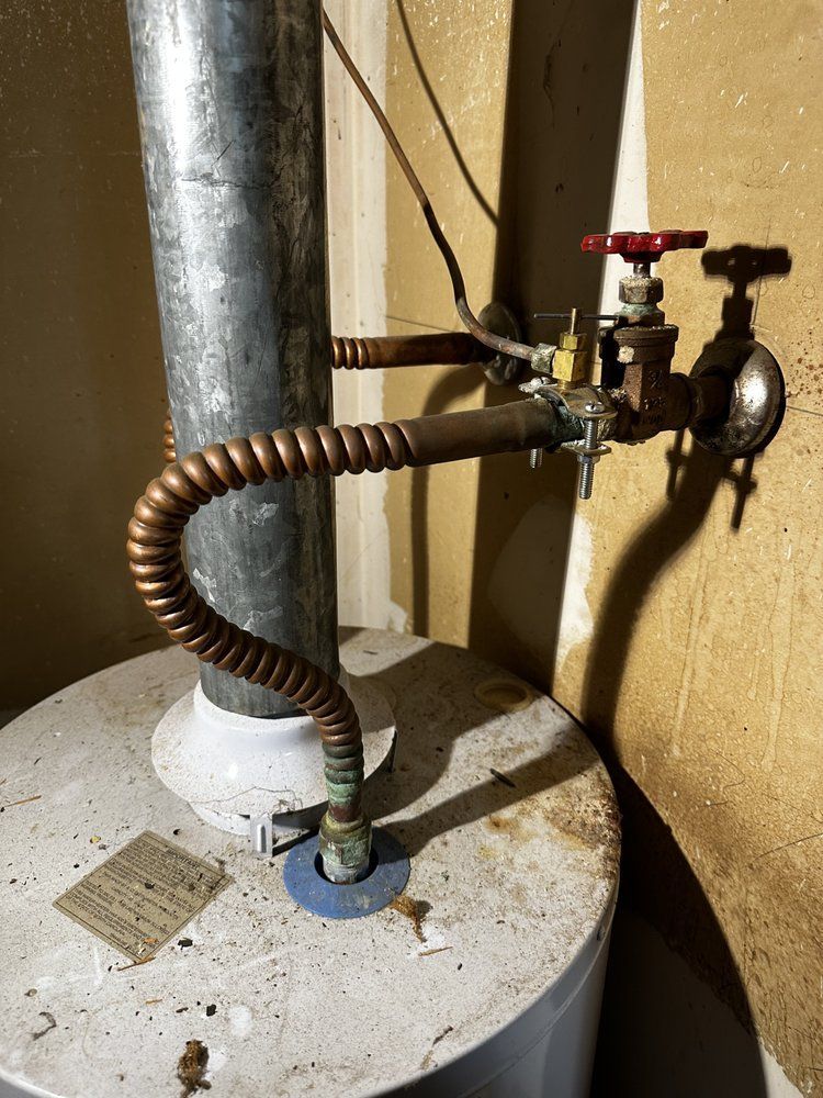 A water heater with a hose attached to it