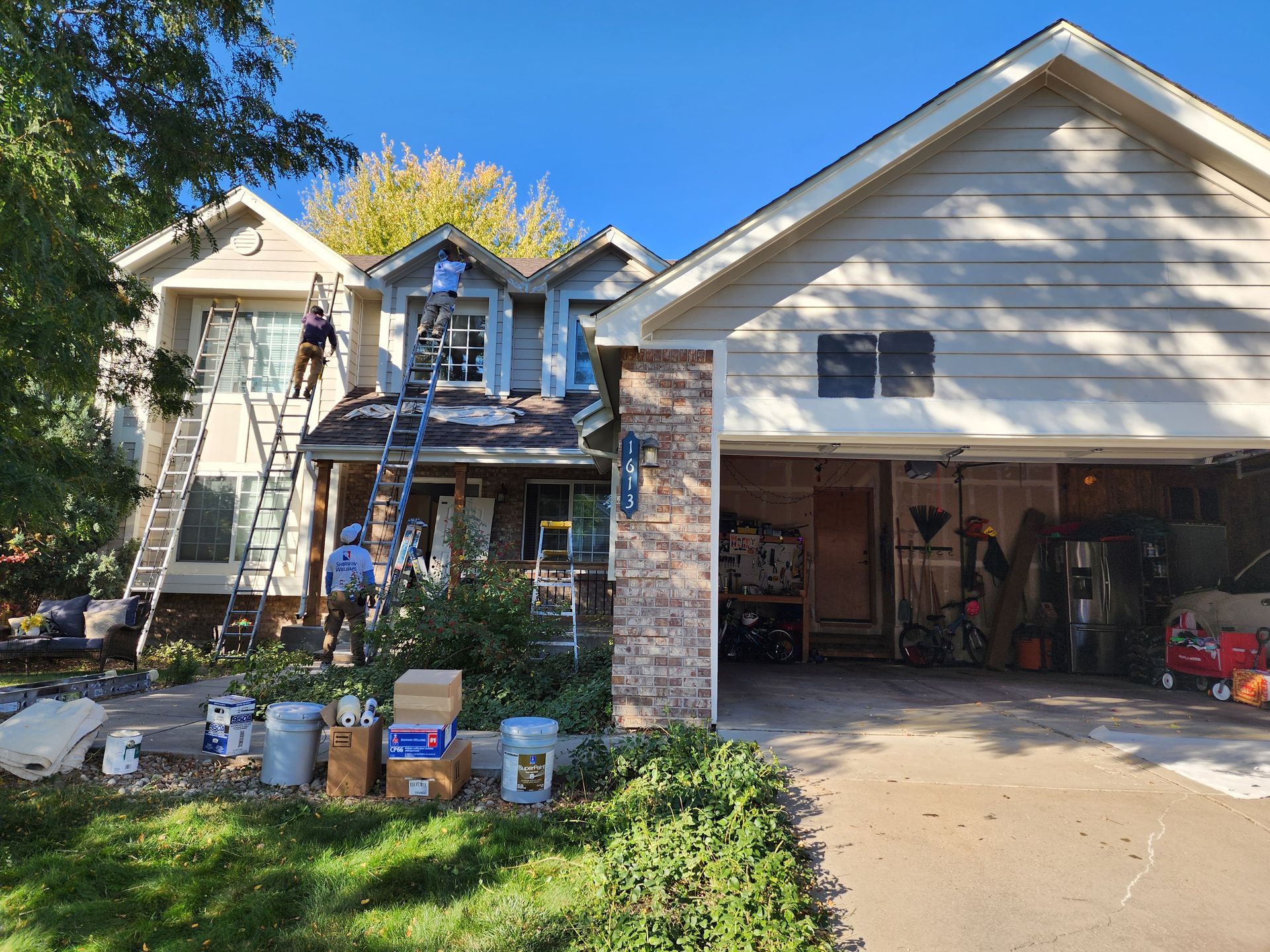 Residential Siding and Trim Replacement by Tri-Plex Painting. Tri-Plex Painting crew painting the exterior of a residential home
