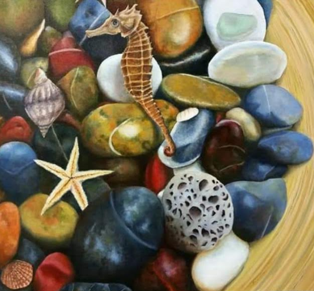 Close-up of colorful pebbles, seashells, and a seahorse. Brown, blue, and white hues dominate.