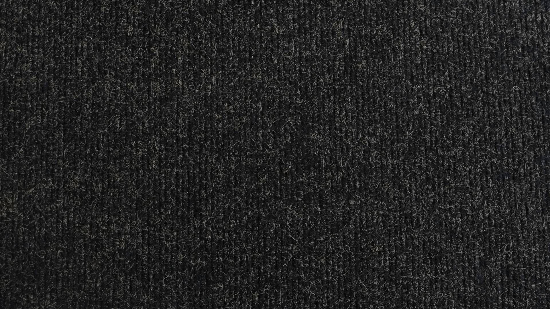 A close up of a black carpet texture.