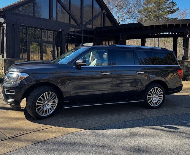 A black suv is parked in front of a building