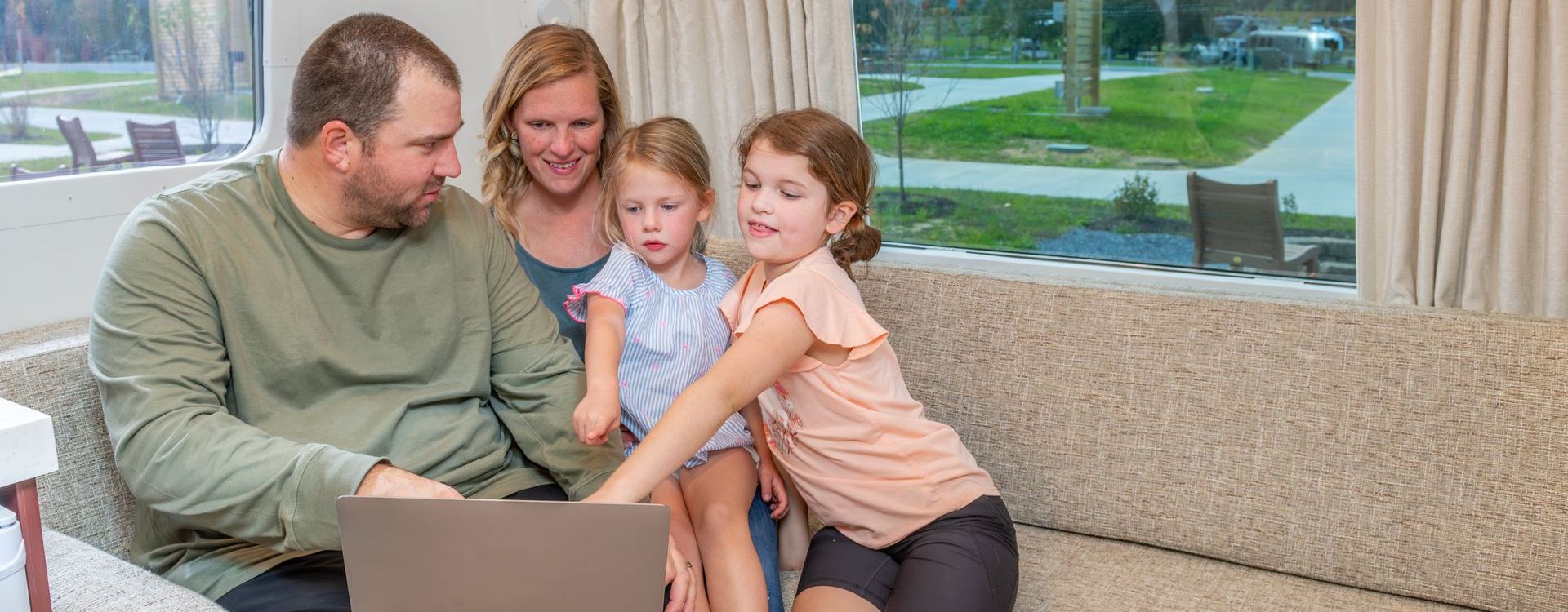 Family in RV with computer