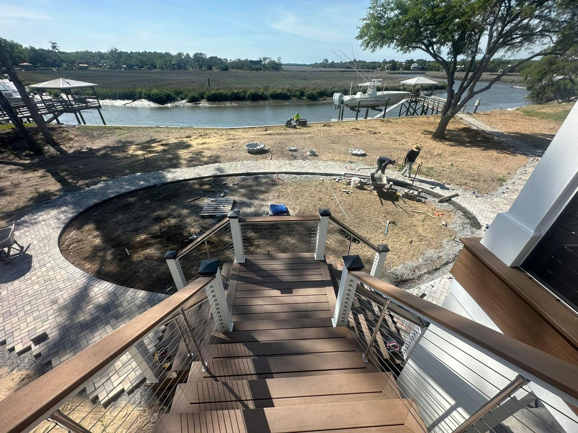 View from steps down to a waterfront area with newly landscaped circular area.
