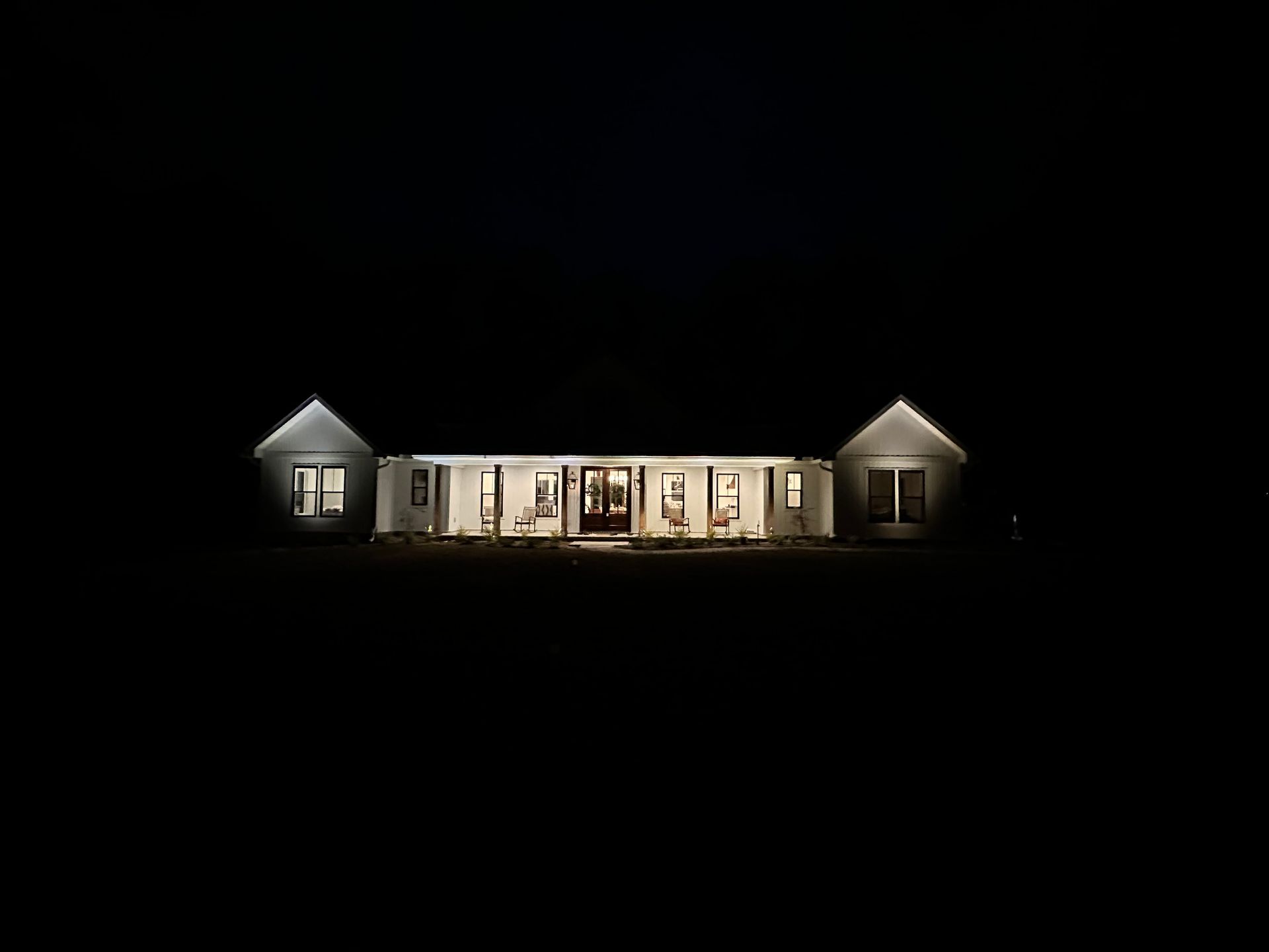 White house illuminated at night.