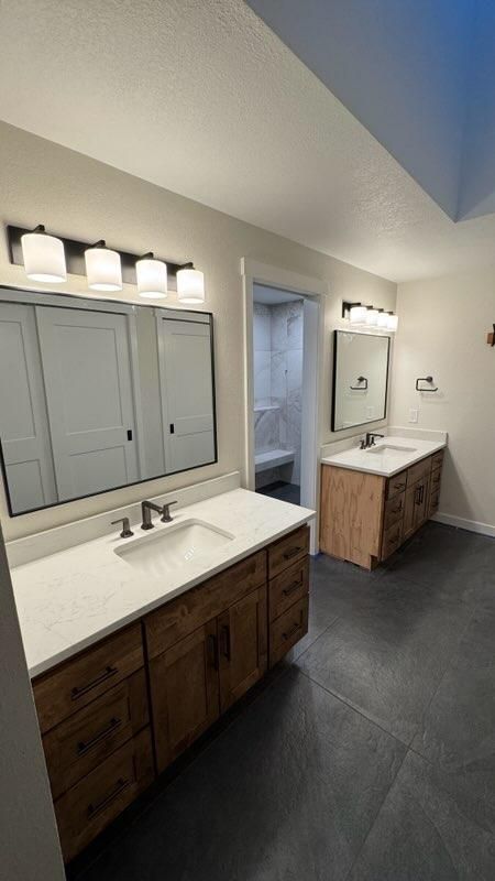 Double vanity with custom wood cabinets and quartz countertops in a bathroom remodel in Bellingham, WA.