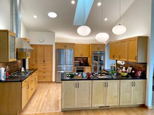 Kitchen remodel in Bellingham, WA with custom wood cabinetry, center island, and modern finishes.