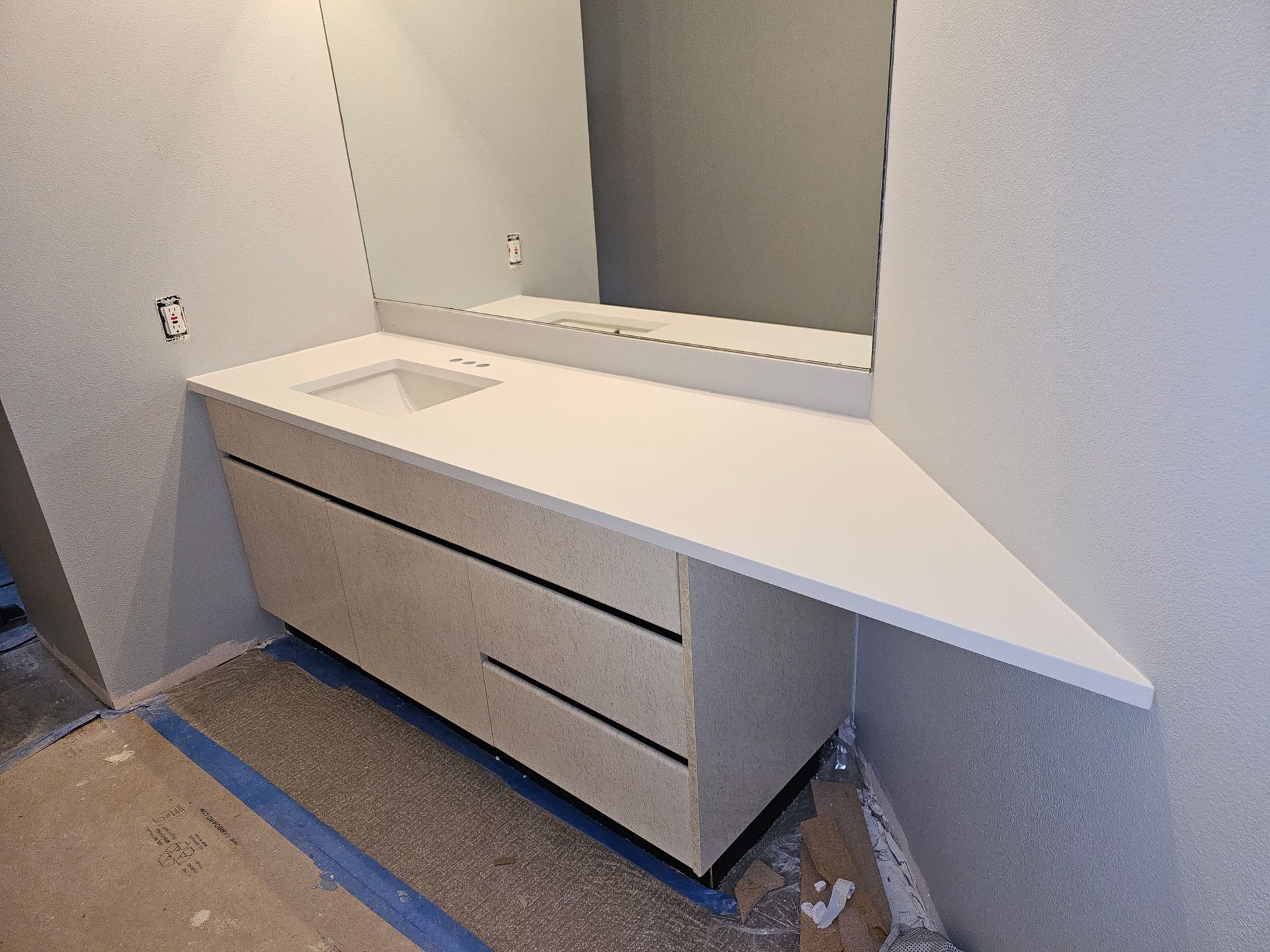 Custom floating vanity with a quartz countertop in a bathroom remodel in Bellingham, WA by Alderwood Builders LLC.