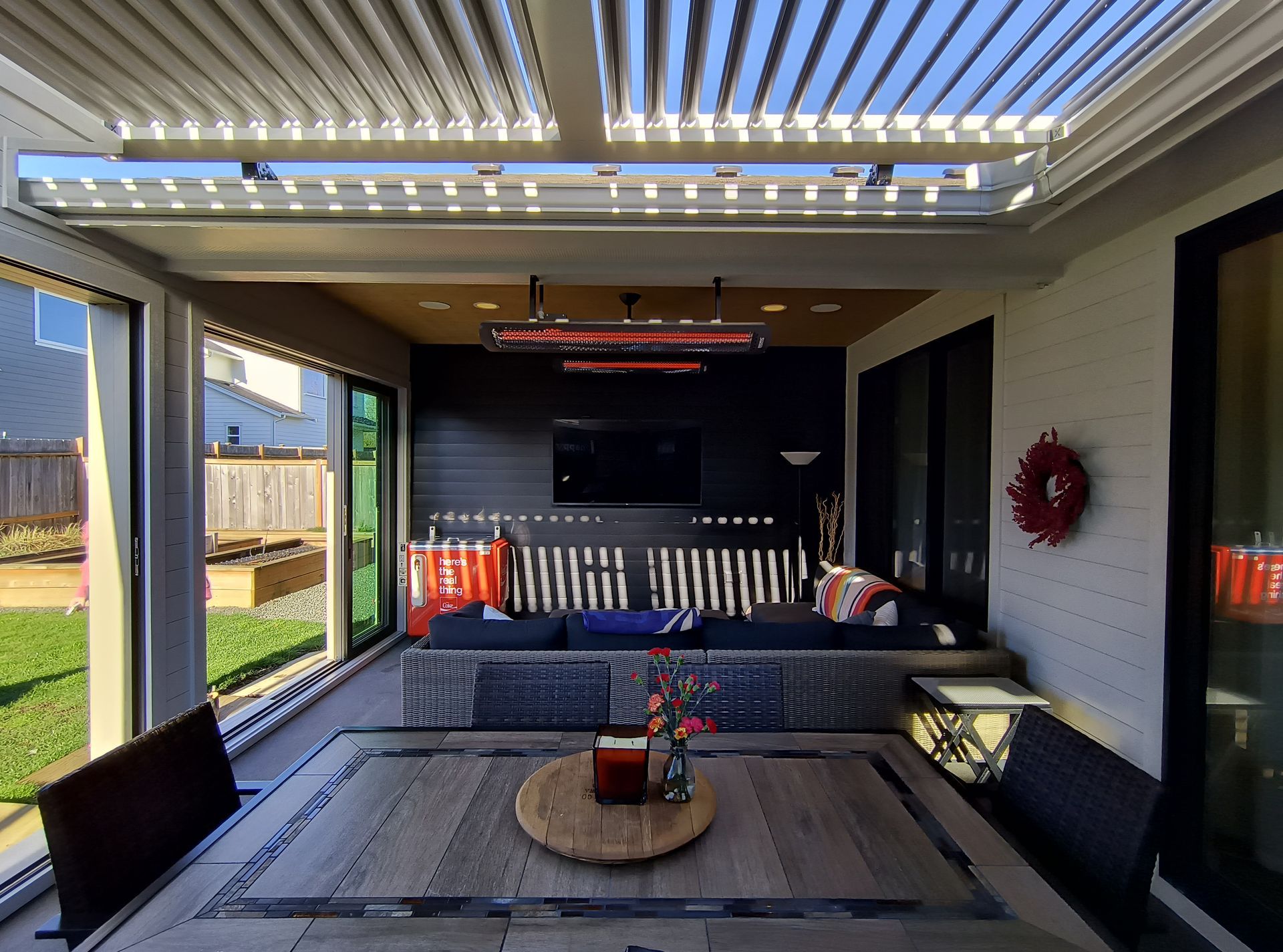 Covered outdoor living space with pergola and patio seating in Bellingham, WA.