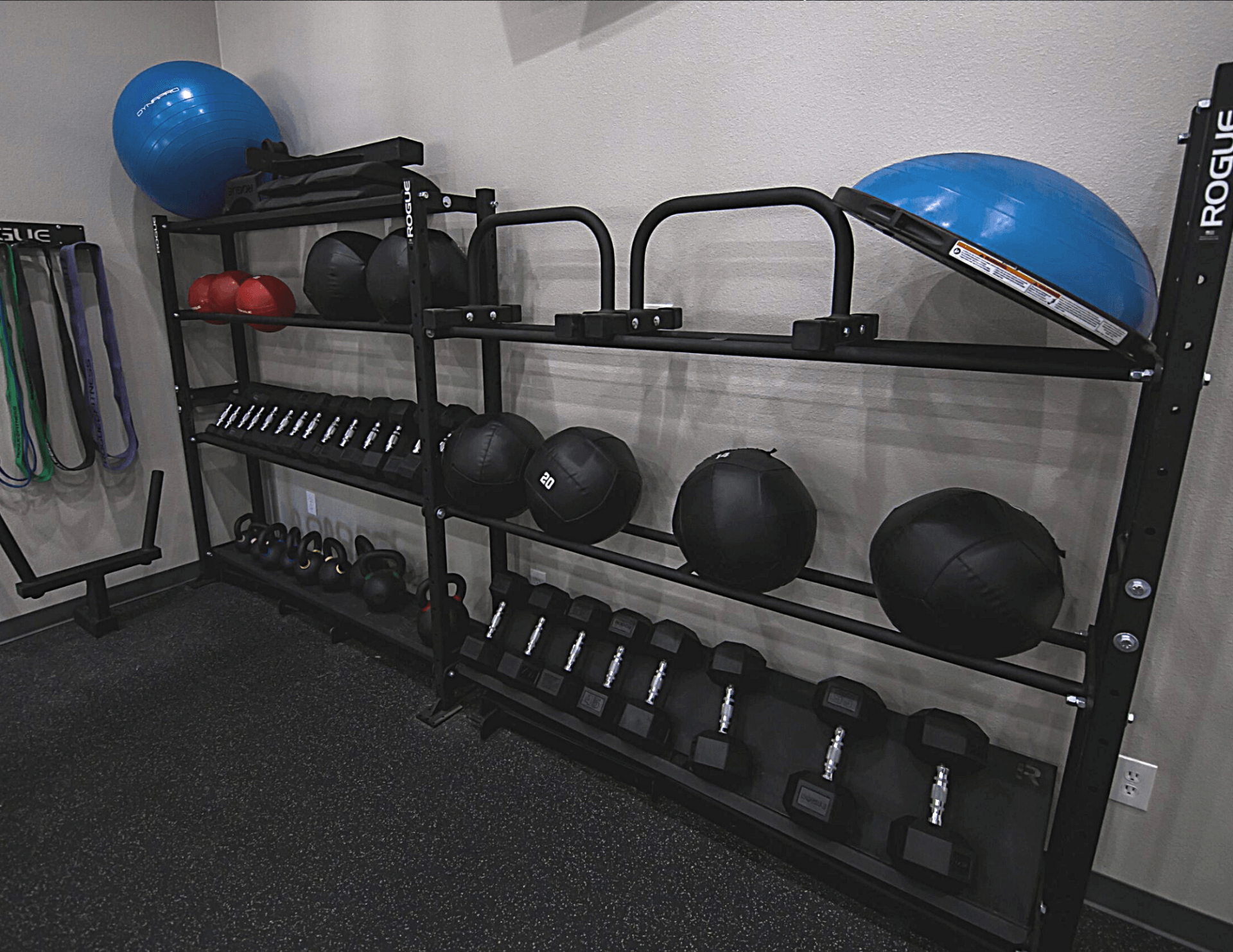 Interior of fitness center with dumbbells and weight balls