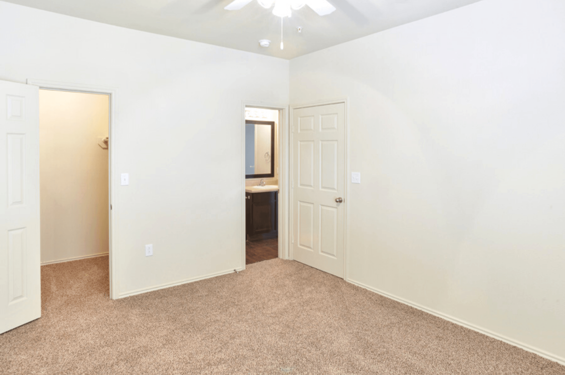 Interior of bedroom with closet and ceiling fan