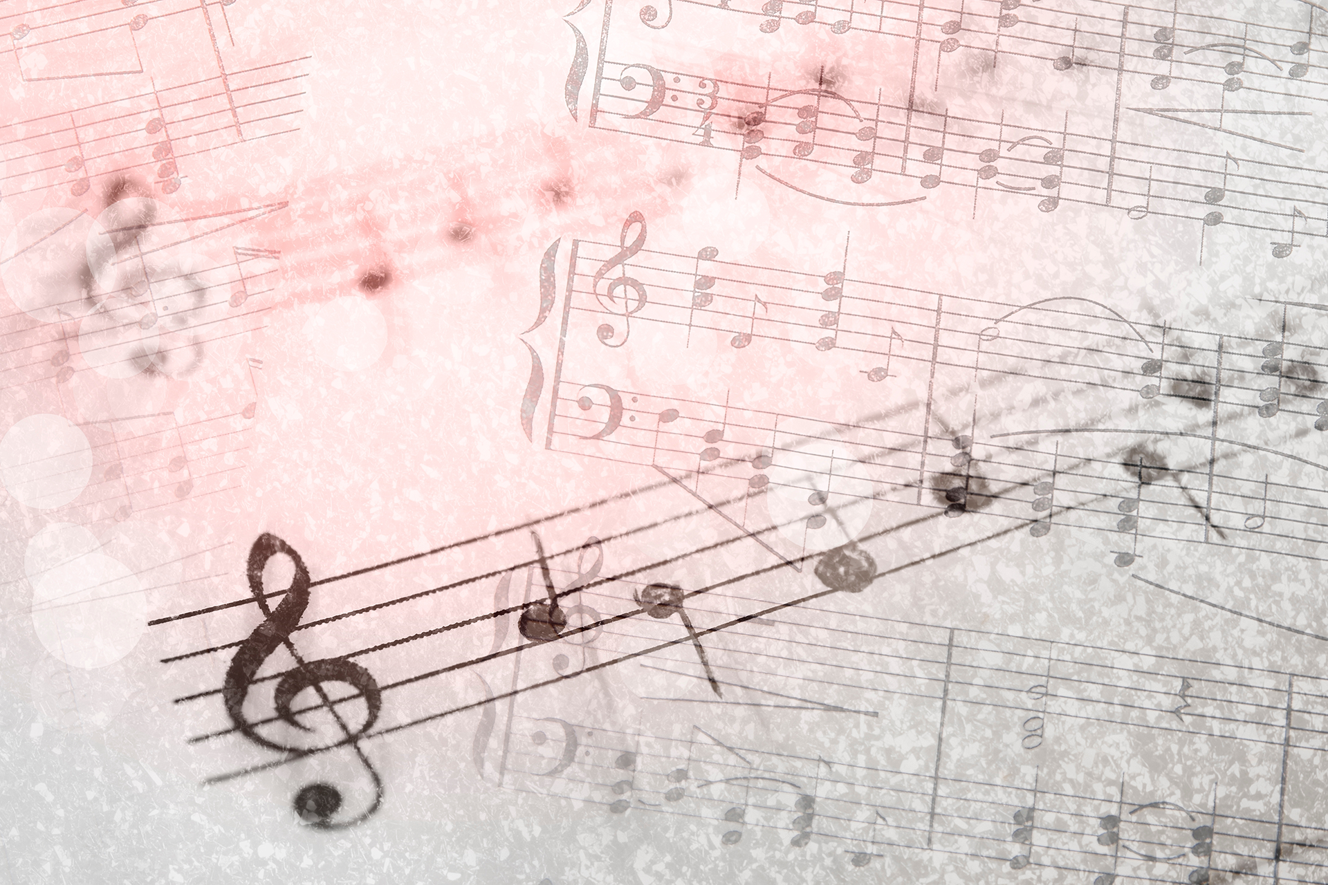 A close up of a sheet of music with a treble clef