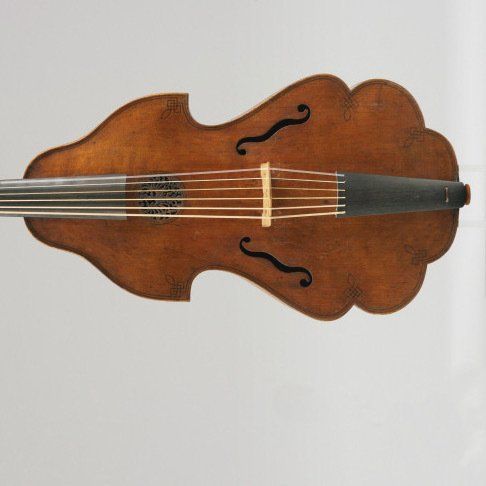 A violin is laying on top of a sheet of music