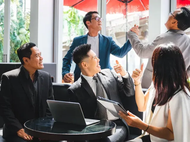 A group of business people are having a meeting in a cafe.