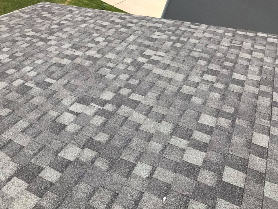 Gray patterned paving stones in an outdoor driveway or patio area