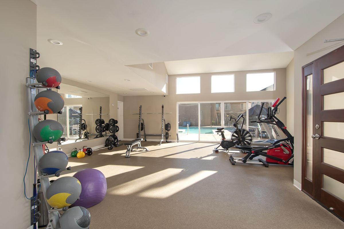 a gym with a lot of balls and exercise equipment