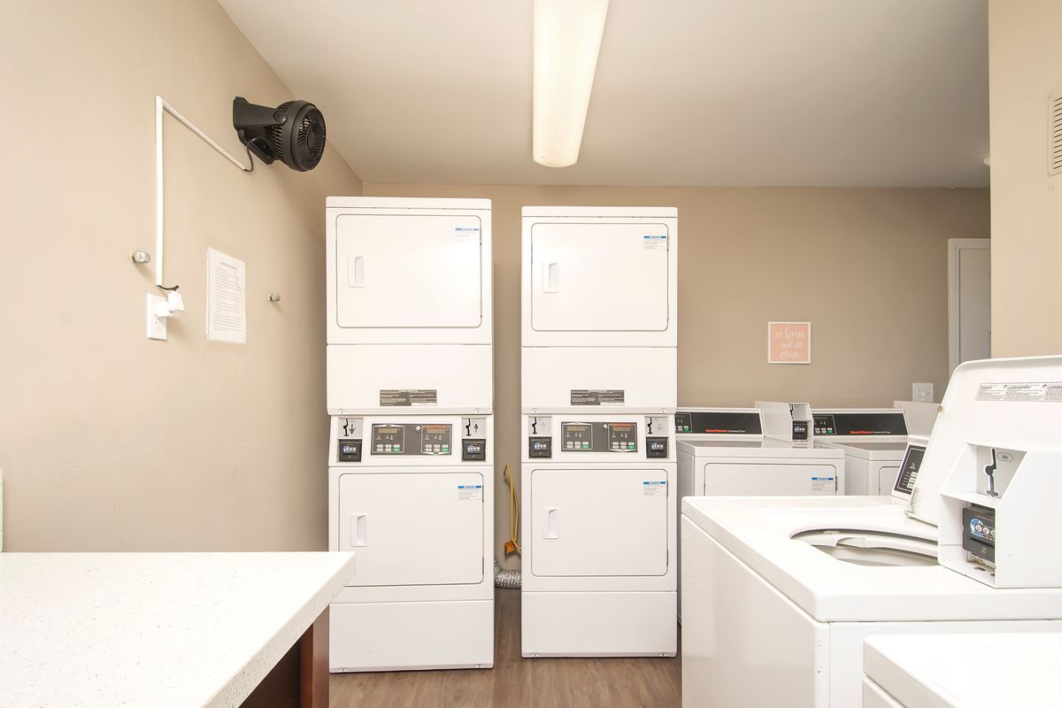 a laundromat with washers and dryers stacked on top of each other
