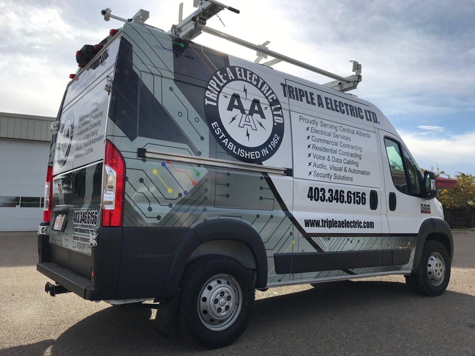 White Triple A Electric van with logo and contact info parked outside.