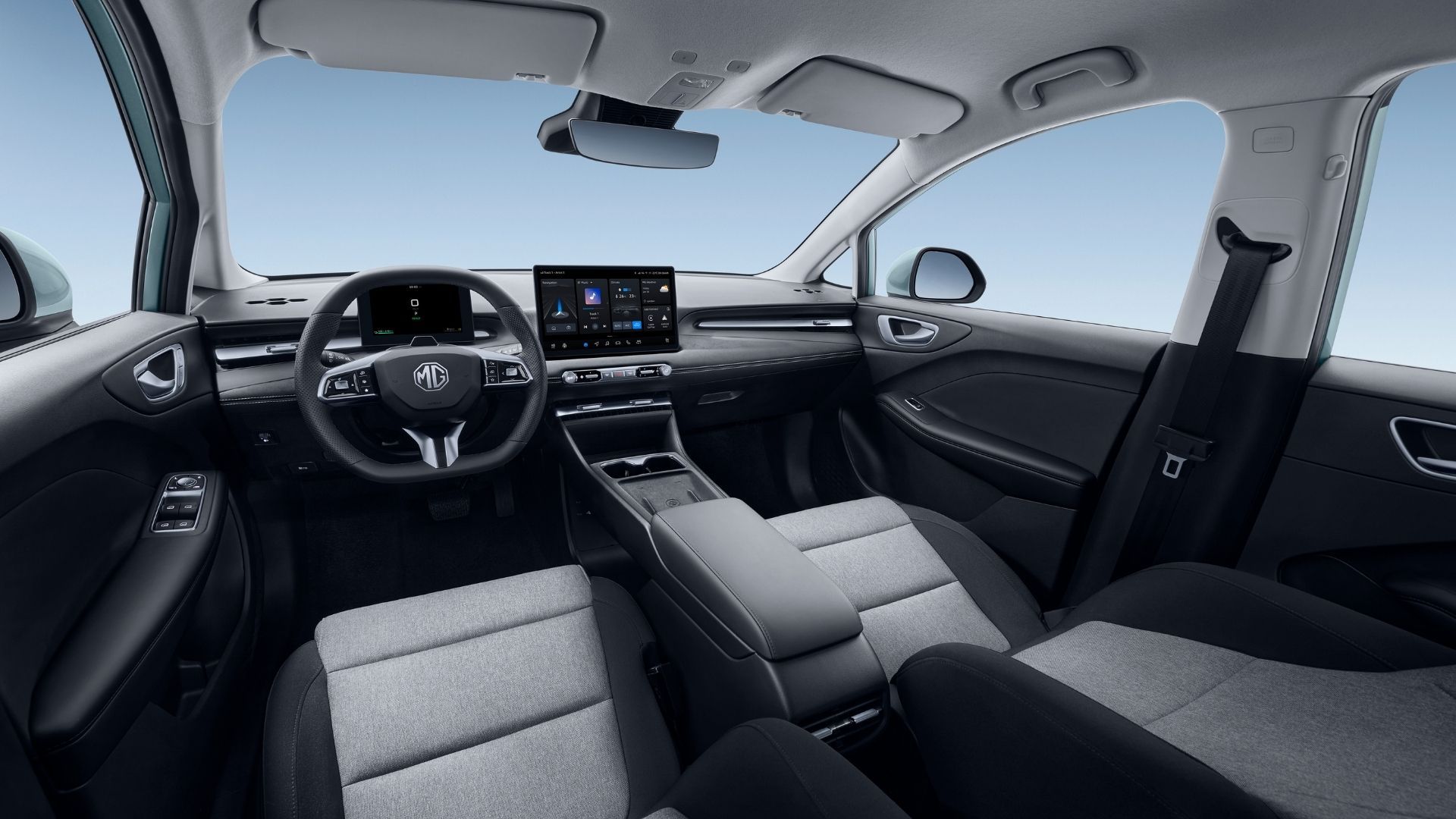 Wide view of a car’s front cabin with gray seats, black dashboard, and center touchscreen