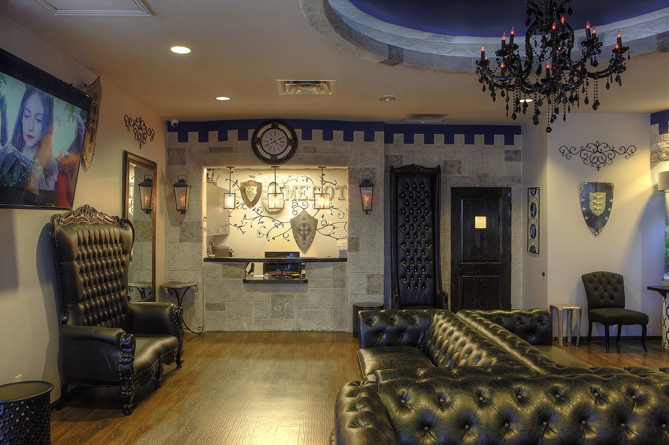 Elegant hotel lobby with tufted leather chairs, chandelier, wall art, and warm lighting