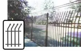 Metal fence with sharp angled spikes in front of a street and trees