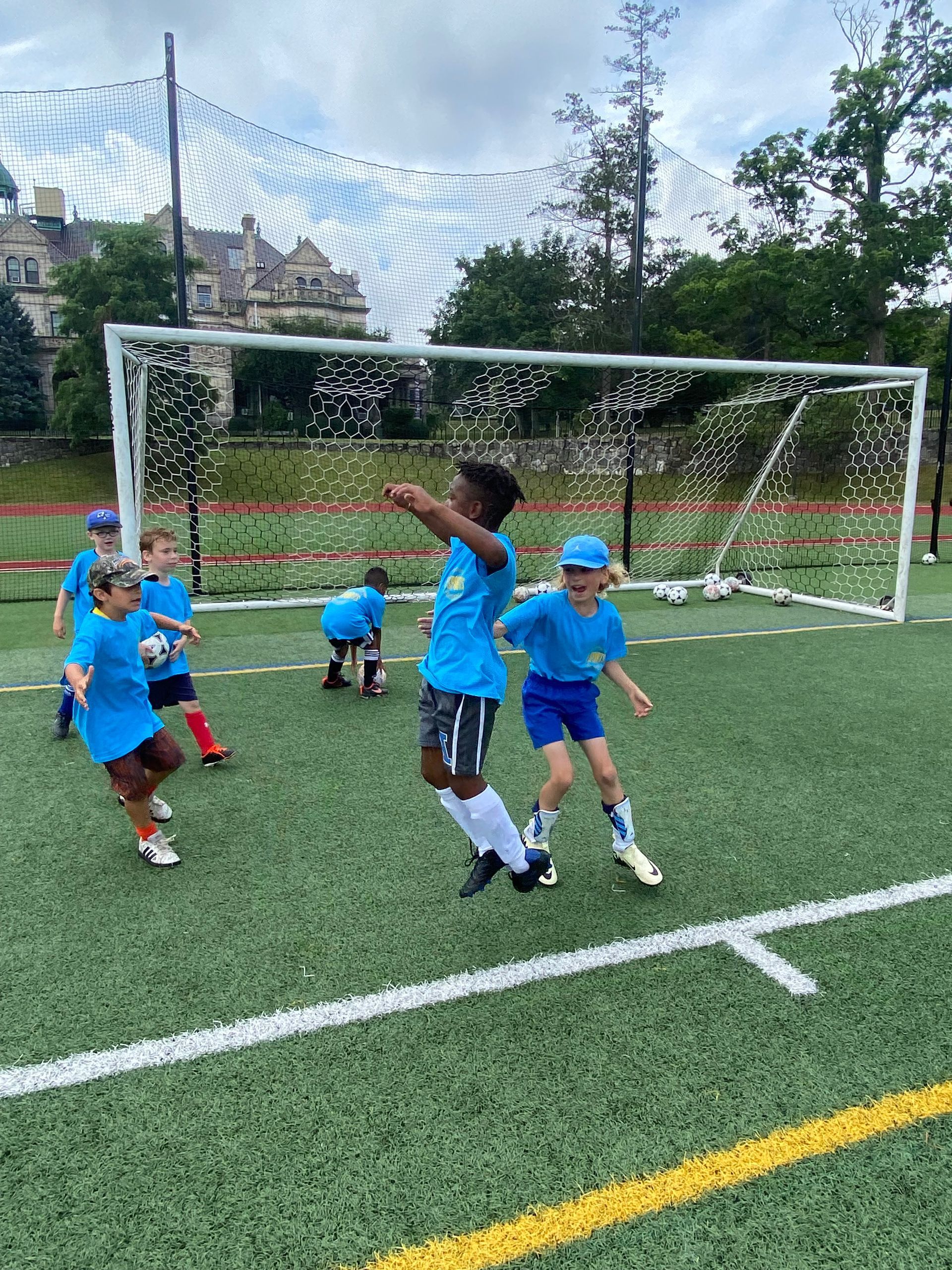 A group of children are playing soccer on a field.