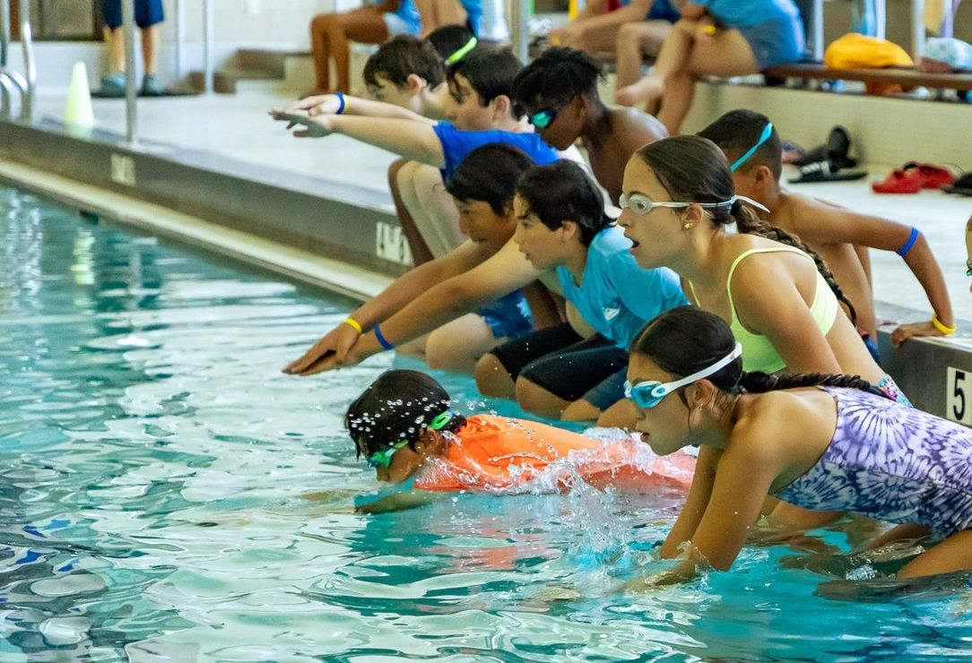 A person is swimming in a swimming pool.