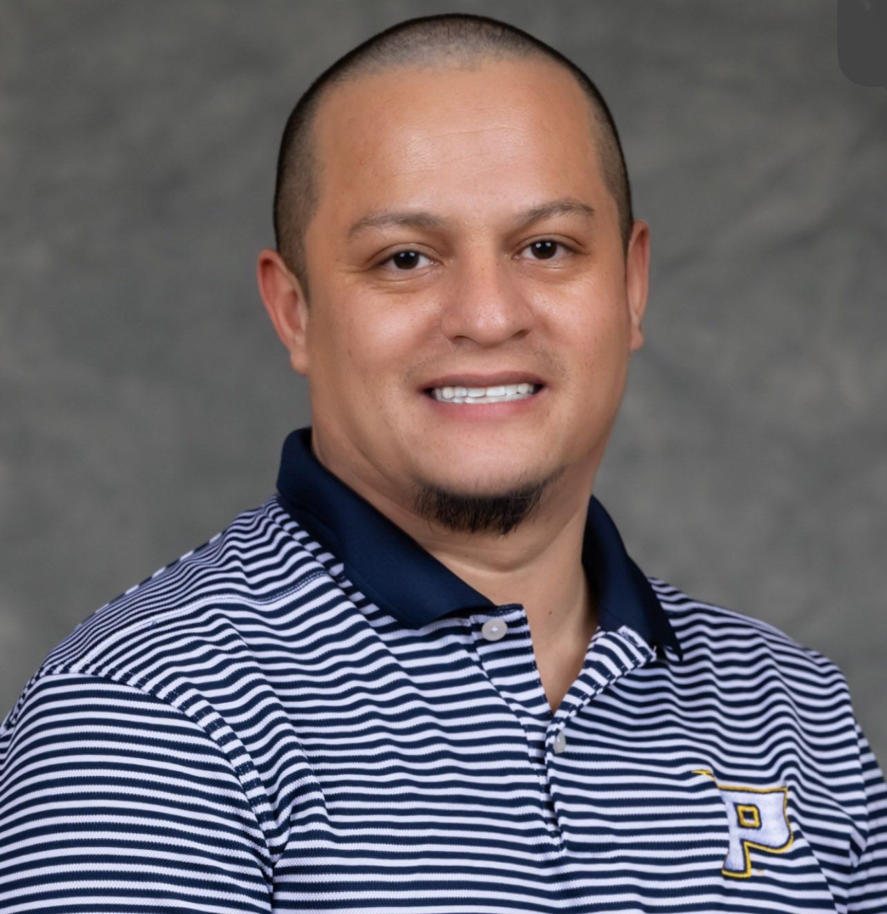 A man wearing a striped shirt with the letter p on it
