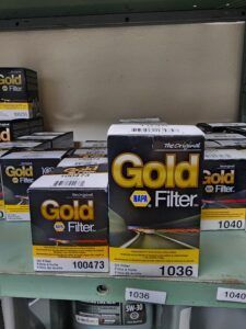 Boxes of NAPA Gold oil filters in a store.
