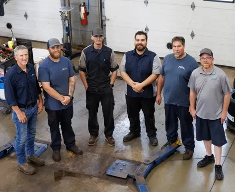 Our team of auto mechanics standing in our garage in Slinger, WI | Joe's Slinger Service, LLC