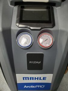 A close-up of a Mahle ArcticPRO R1234yf A/C service unit, featuring gauges and a display.
