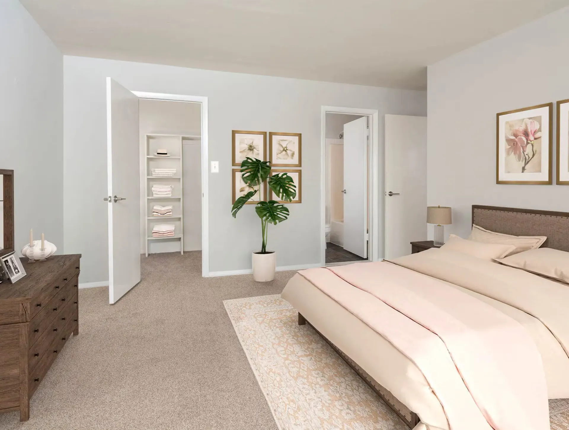 Bedroom in a neutral-toned apartment with a large bed, dresser, plant, and an open shelving closet.
