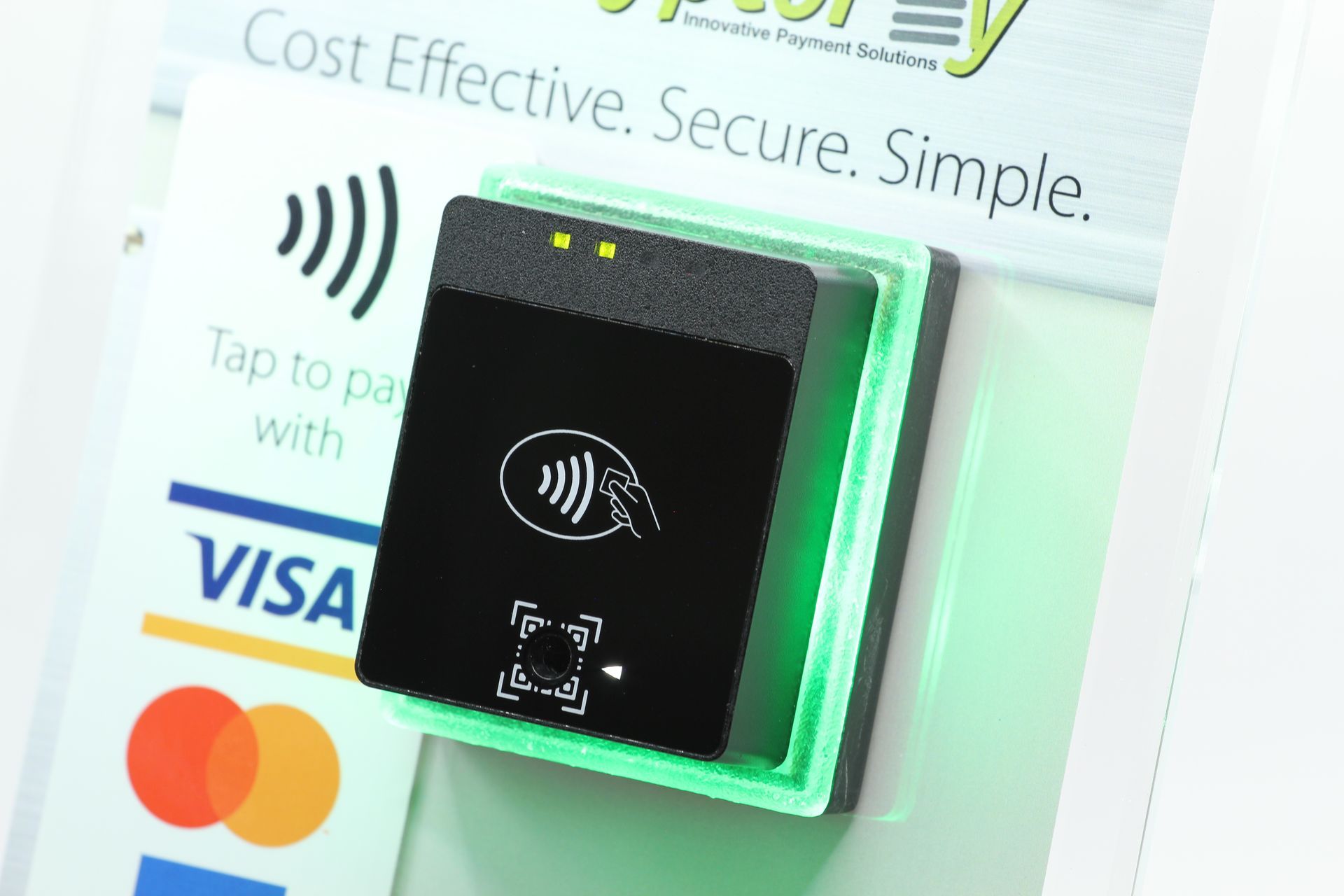 Contactless payment terminal with Visa and Mastercard logos on a promotional display.