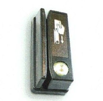 Black wall-mounted box with a small white figure icon and a circular button on the front.