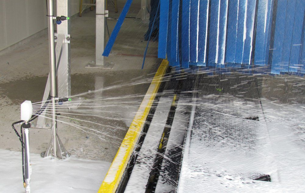 A machine is spraying water on a concrete floor.