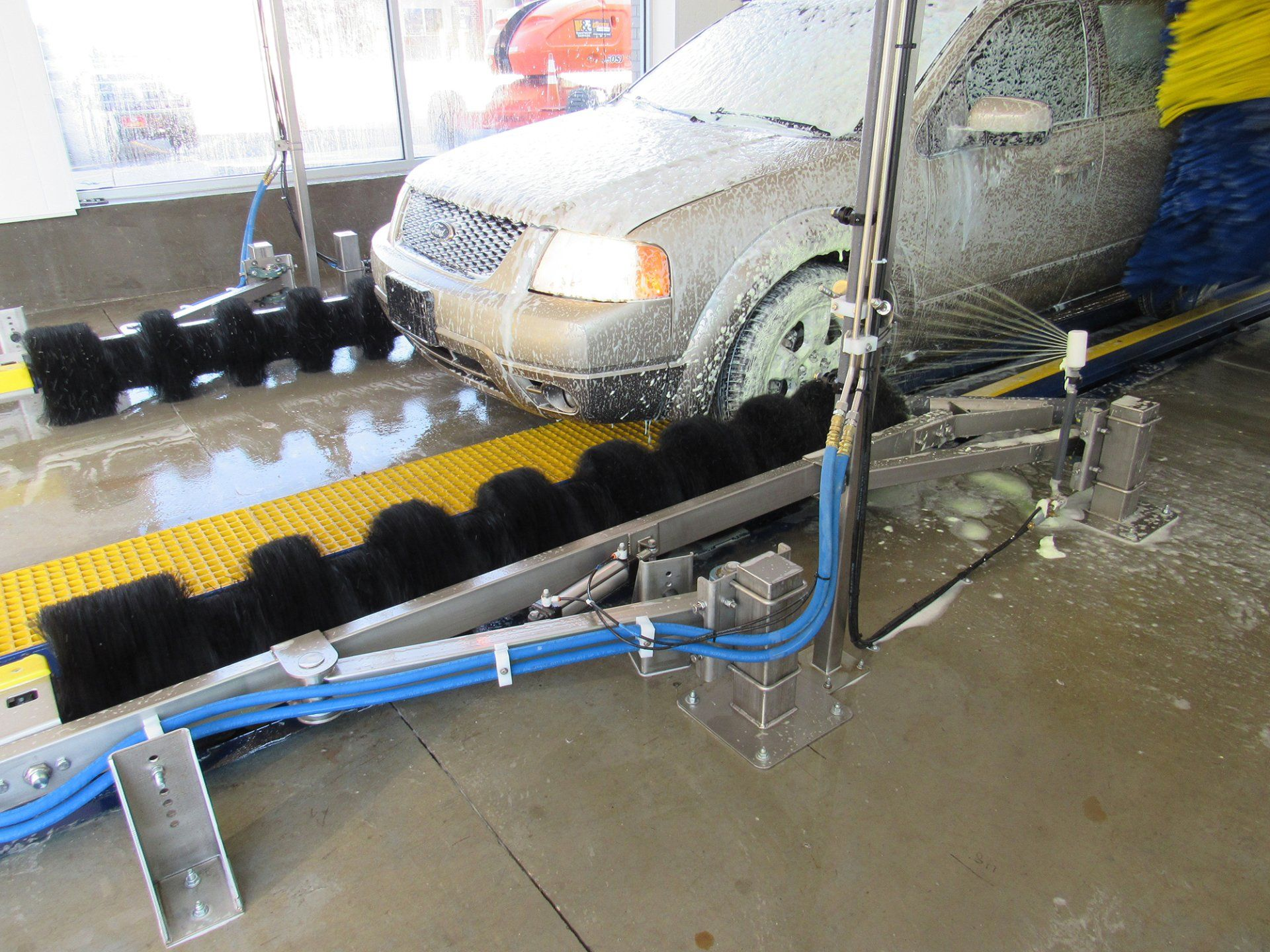 A car is being washed in a car wash.
