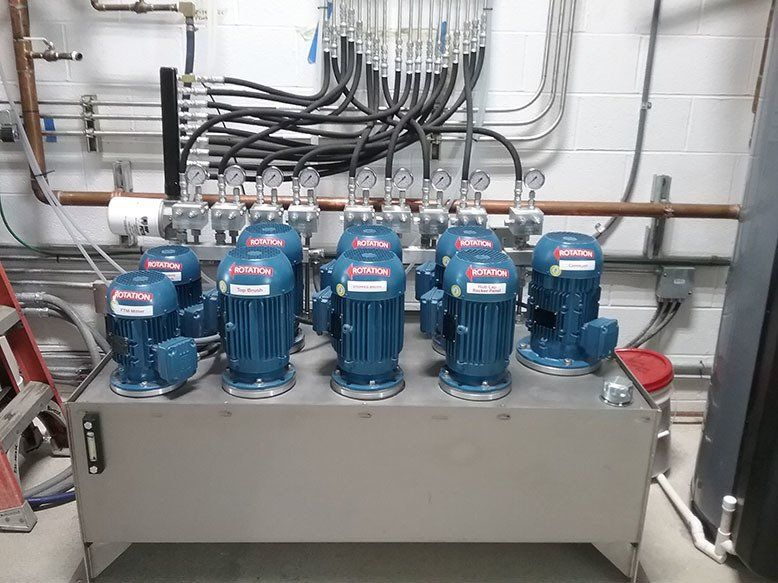 A bunch of blue motors are sitting on top of a metal box.